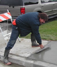 Man Patching Sidewalk
